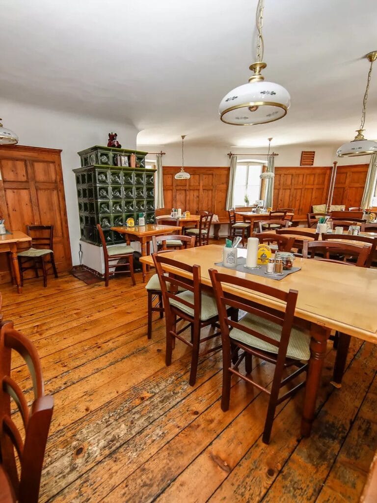 A golden-brown, crispy plate of Austrian Backhendl (fried chicken) served with a traditional potato-lamb’s lettuce salad at Bärenwirt.