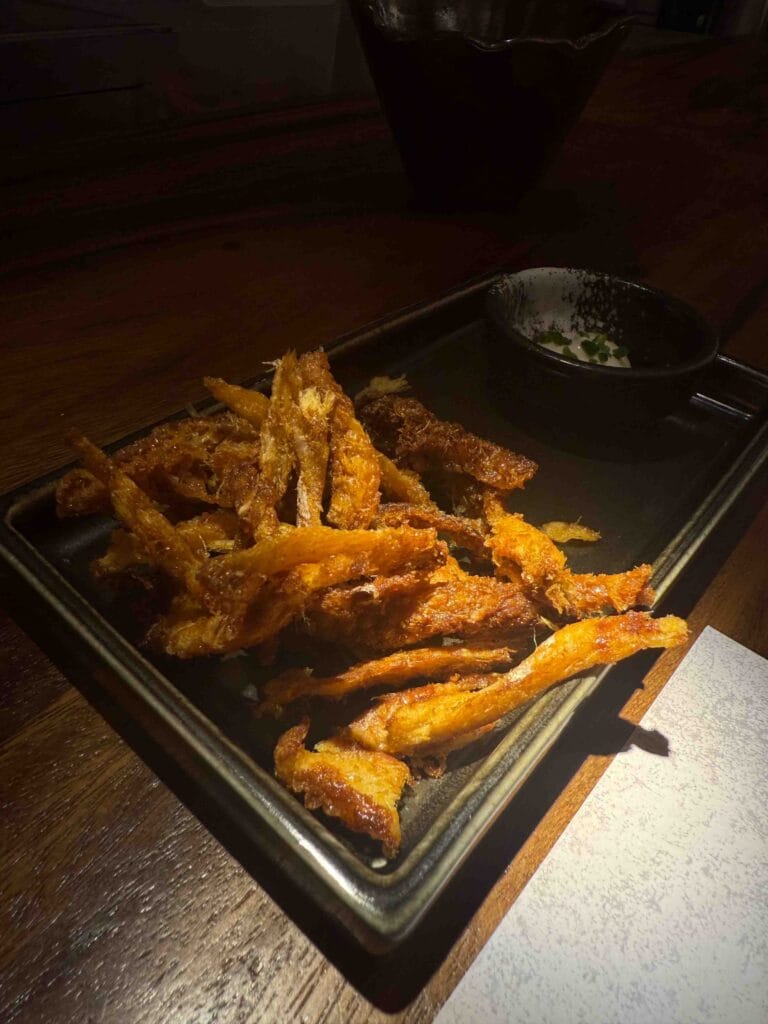 Crispy dried fish strips with dipping sauce served as the Modu Appetiser at MODU Samgyetang Singapore