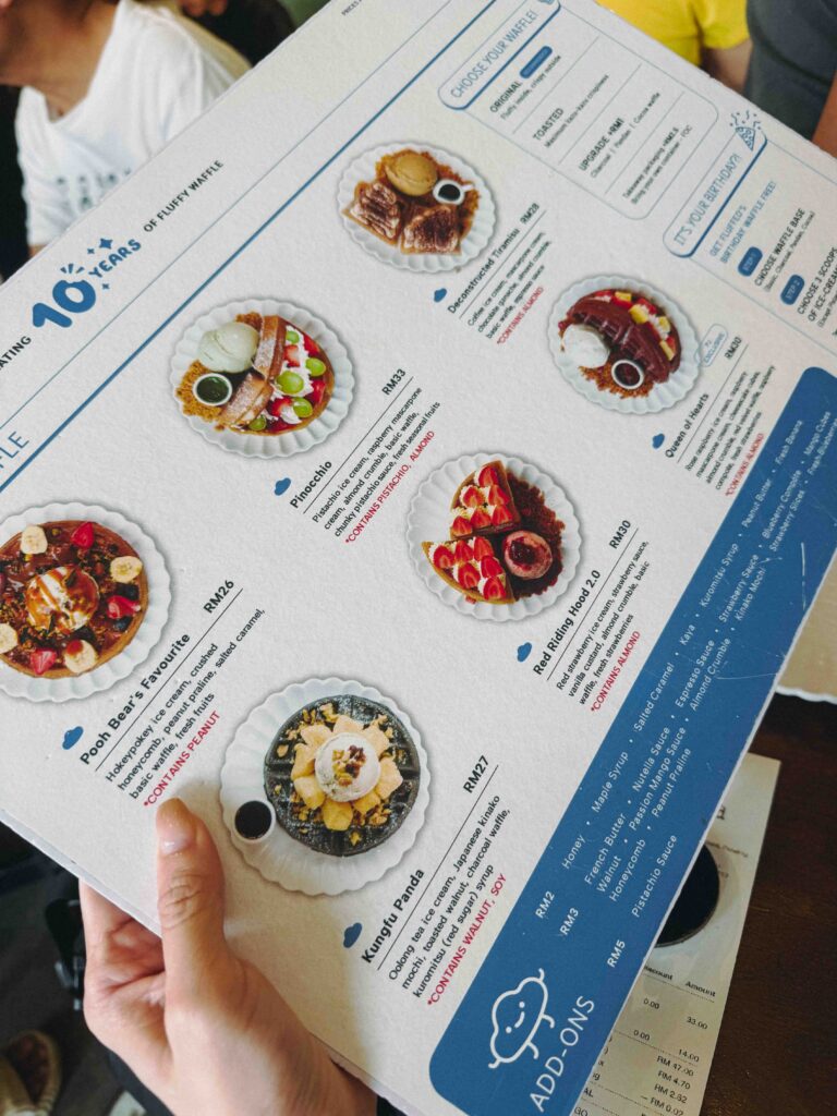 Fluffed Cafe waffle menu showing Pinocchio, Deconstructed Tiramisu, and Red Riding Hood waffles