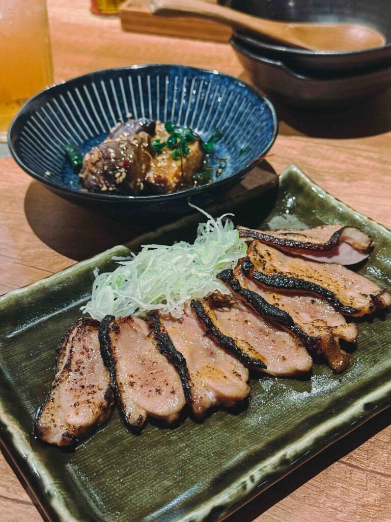 Kamo light grilled miso marinated duck slices on a green ceramic plate at LILYAN Singapore