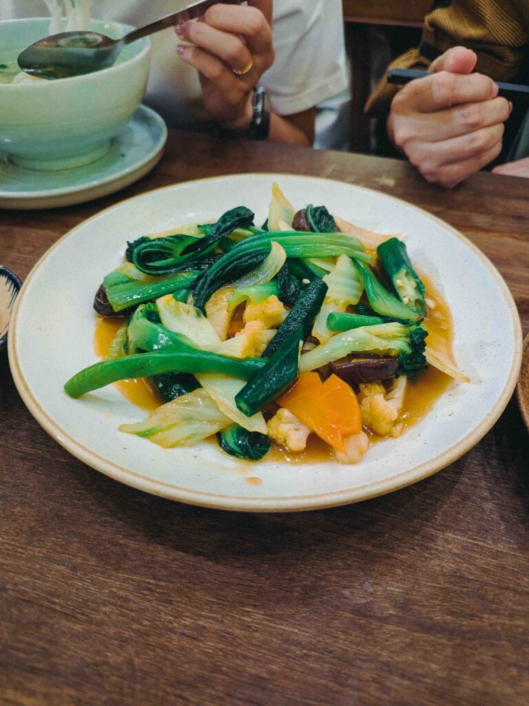 Wok-fried mixed vegetables with bok choy, broccoli, carrot and mushrooms in a light savoury sauce at Cơm Linh Hội An