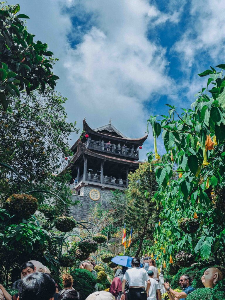 Linh Phong Temple multi-tiered pagoda tower rising above lush green gardens at Ba Na Hills Da Nang