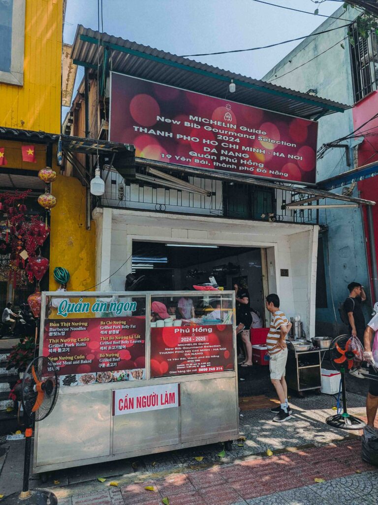 Quán Phú Hồng restaurant exterior in Da Nang with Michelin Guide Bib Gourmand 2024 sign and grilled pork menu board